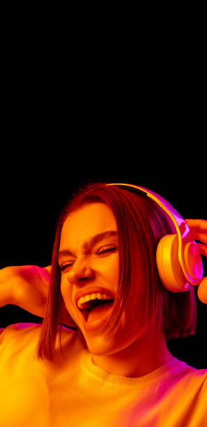 istock Caucasian woman's portrait isolated on black studio background in multicolored neon light 1299090865