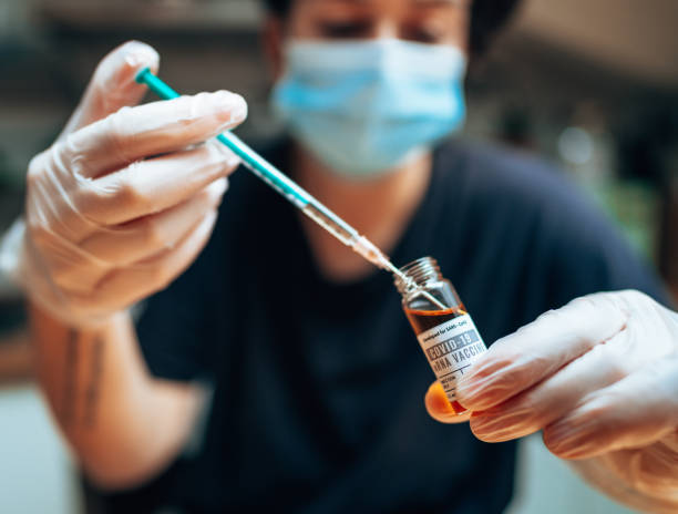 istock Pharmacist holding the Covid19 vaccine vials 1299092635