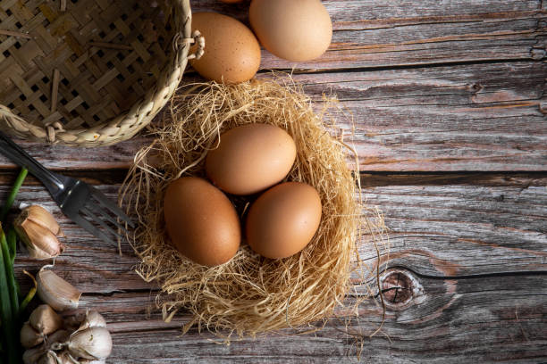 istock Brown chicken eggs on wooden background. Raw eggs. Fresh natural eggs. 1299092662