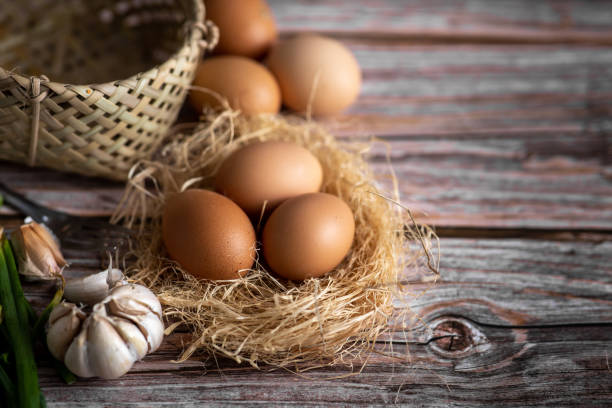 istock Brown chicken eggs on wooden background. Raw eggs. Fresh natural eggs. 1299092747