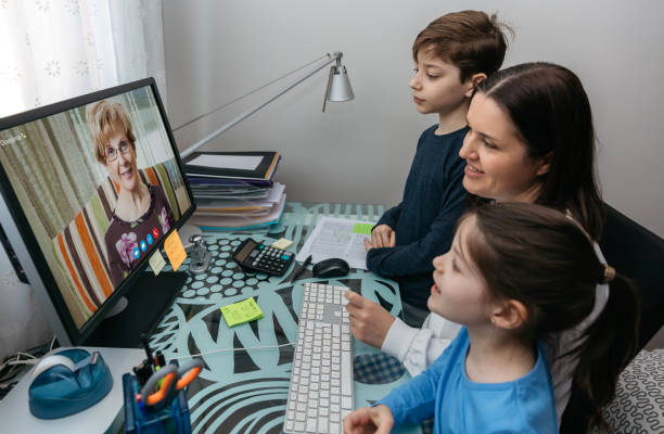istock Family talking on video call with grandmother 1299094268