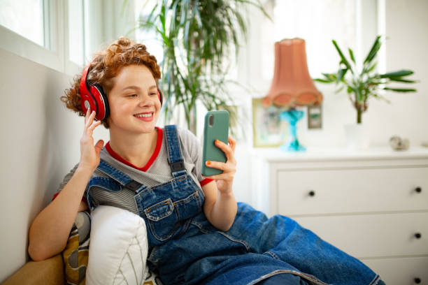 istock Happy Caucasian redhead woman using a smart phone at home 1299096218