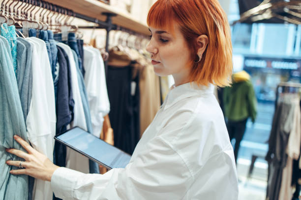 istock Fashion store owner taking stock 1299096854