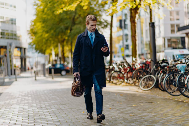 istock Banker going to work with leather bag and blue suit 1299098881
