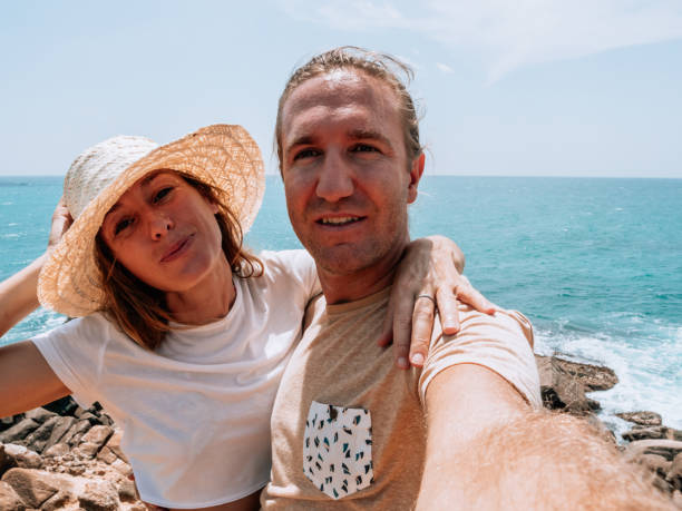 istock Couple take selfie by the coastline 1299103288