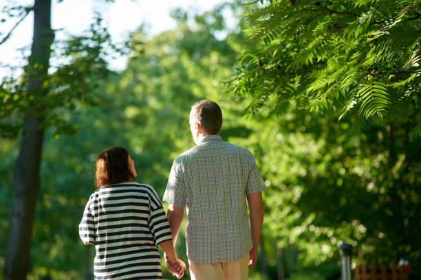 istock Mature couple walks in the park. 1299103329