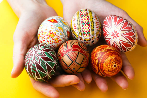 istock happy easter card. girl holds in hands beautiful Easter egg Pysanka handmade - ukrainian traditional 