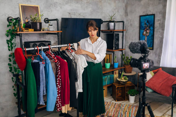 istock Charming female influencer recording e-commerce for a clothing brand 1299104685