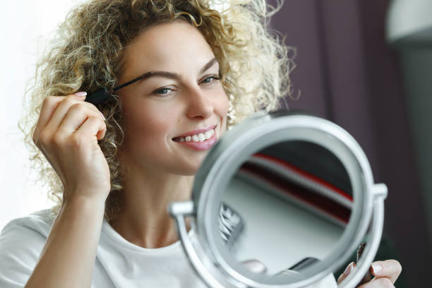 istock Young beautiful woman is using eyebrow tinting brush 1299104777