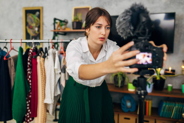istock Passionate ypoung female vlogger adjust her camera and microphone so she can start to record a fashion vlog 1299104905