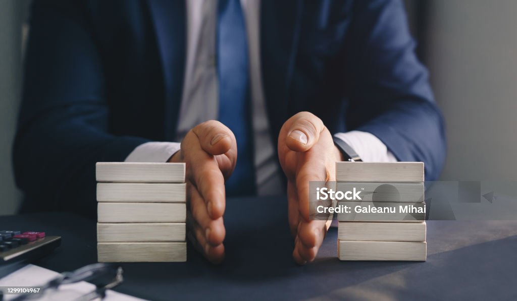 Businessman separates wooden block. Concept of wealth equality. Division of property. Divorce and legal services. Businessman separates wooden block. Concept of wealth equality.
Division of property. Divorce and legal services Separation Stock Photo