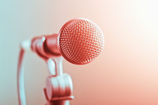Close-up of a microphone under bright lighting.