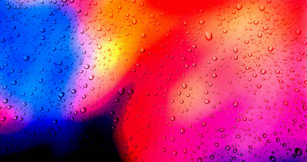 istock Rain drops on colorful glass window background. 1299105799