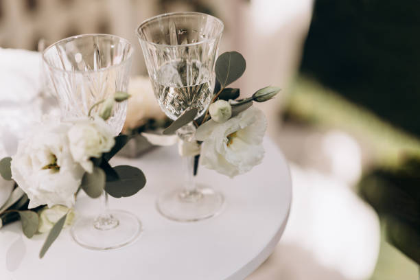 istock two crystal glasses for a wedding couple 1299106556