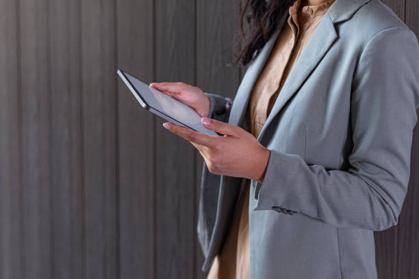 Technology Based Business: Cropped Shot of an Anonymous Asian Woman Using a Digital Tablet Outdoors Hands of a businesswoman holding a digital tablet image based social media photos stock pictures, royalty-free photos & images