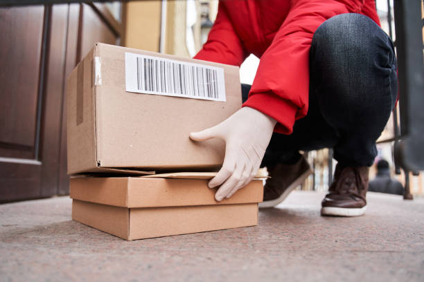 istock Courier has come at house and putting box near entrance 1299108220