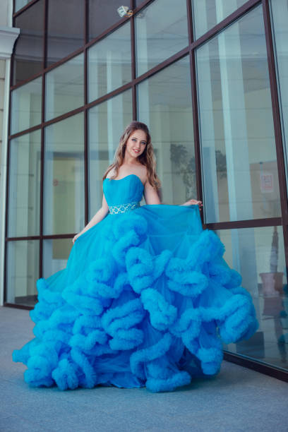 istock Beautiful model in a blue dress over neutral background 1299108653