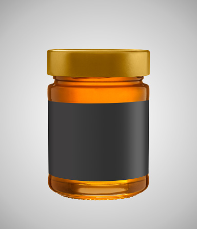 Honey in jar mock up isolated with black label on gray background. Label and jar has a clipping paths.