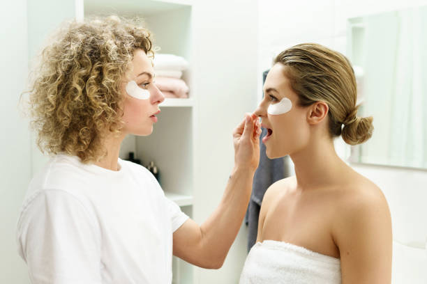 istock Two beautiful and cheerful girls with applied under-eyes patches 1299108833