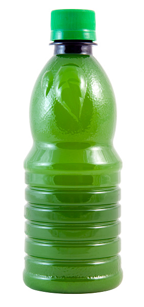 Lime juice in a green plastic bottle. Isolated.