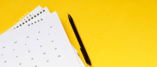 istock White clean calendar on solid yellow background with copy space, business meeting schedule 1299113448
