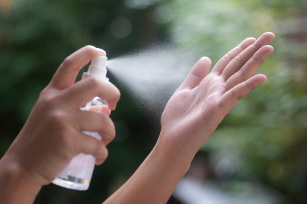 istock Woman spraying antiseptic on hands close up, selective focus side view Spray disinfection, protection, prevention, COVID-19 1299113550