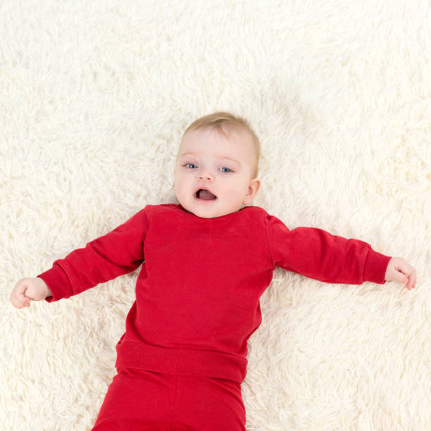 istock The child laughs while lying on his back and looks at his parents 1299114985