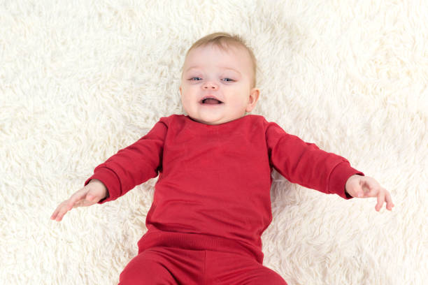 istock The child laughs while lying on his back and looks at his parents 1299114990