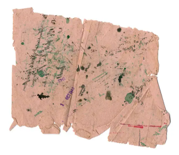 A piece of heavily-used pink blotting paper from the 1940s, with green, red and black ink stains and purple date stamps.