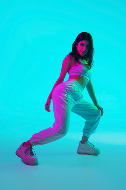 istock Brunette beautiful woman's portrait isolated on blue studio background in multicolored neon light 1299116148