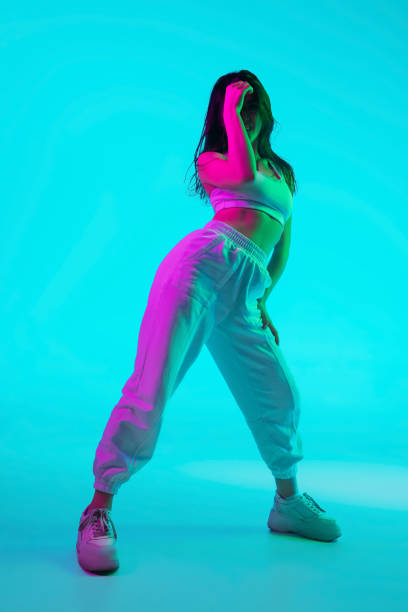 istock Brunette beautiful woman's portrait isolated on blue studio background in multicolored neon light 1299116153