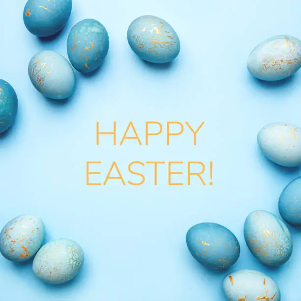 Photo of Easter frame of eggs painted in blue color.