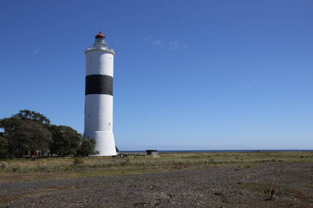istock A black and white lighthouse at the coast 1299119163