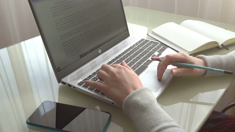 The girl working at home office hands on keyboard.