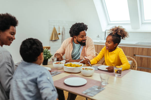 istock Afro family eating together at home 1299119489