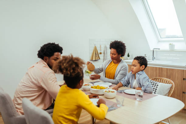 istock Afro family eating together at home 1299119490