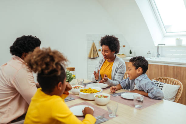 istock Afro family eating together at home 1299119492