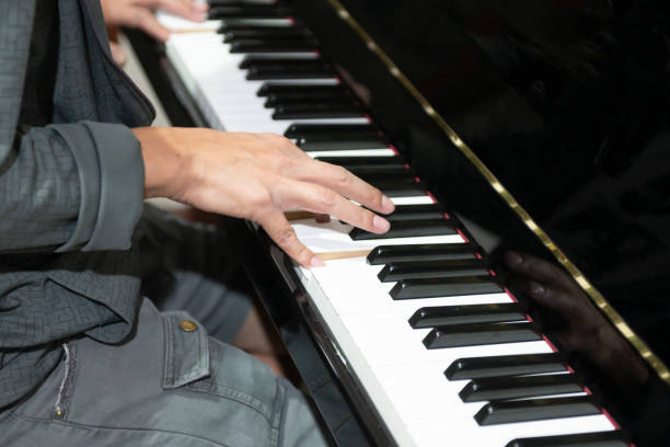 istock The hand that is playing the piano keys 1299120438