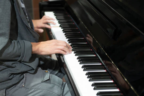 istock The hand that is playing the piano keys 1299120465