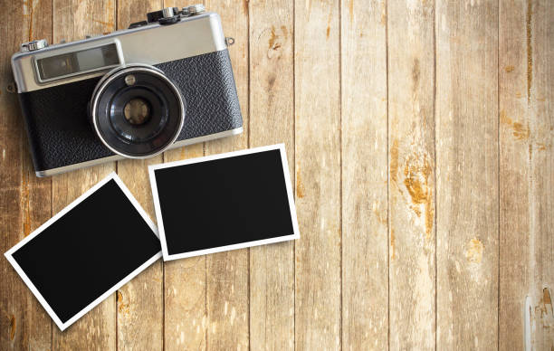 istock intage film camera and two blank photo frames 1299120617