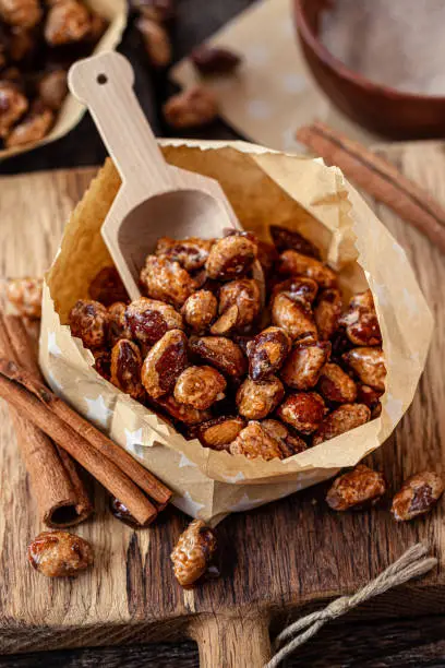 Roasted almonds with cinnamon in little paper bags