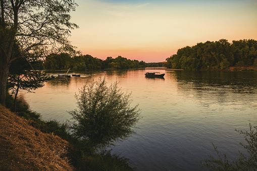 Sleepy river with gently bobbing boats at St Satur on the Loire, France.