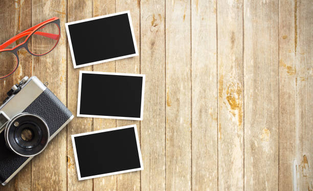 istock Old vintage camera and photo paper 1299120855