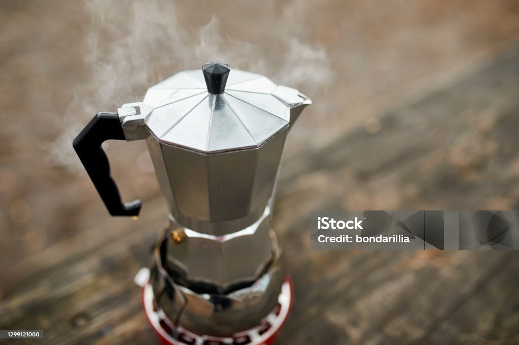 https://media.istockphoto.com/id/1299121000/photo/process-of-making-camping-coffee-outdoor-with-metal-geyser-coffee-maker-on-a-gas-burner-step.jpg?s=1024x1024&w=is&k=20&c=RFzKuWSGc5R_Yd5yRyarOVSpjePWUvLp9_JcqjRO0wo=