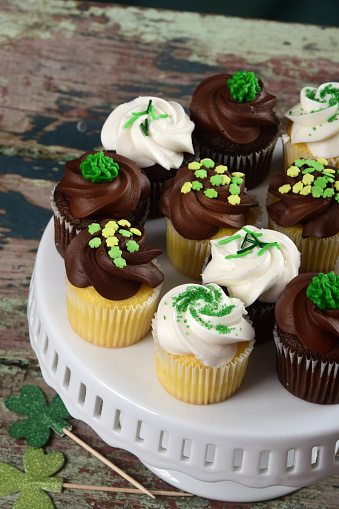 A dozen mini cupcakes decorated for St. Patrick's Day celebration.