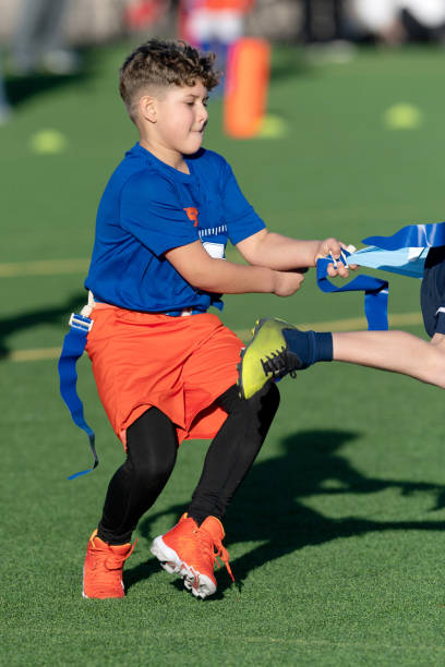 istock Young Athletic Boy Playing Flag Football 1299123580