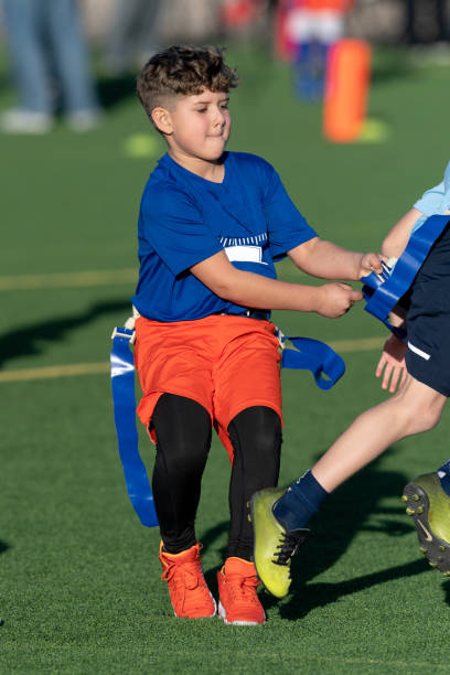 istock Young Athletic Boy Playing Flag Football 1299123583