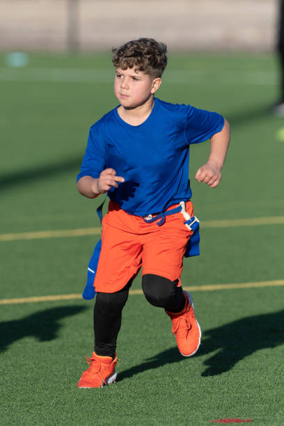 istock Young Athletic Boy Playing Flag Football 1299123585