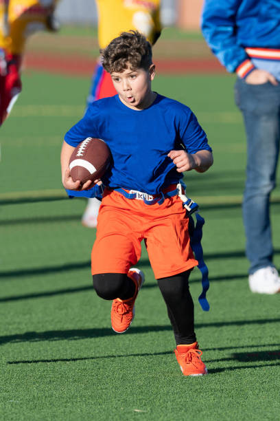 istock Young Athletic Boy Playing Flag Football 1299123587