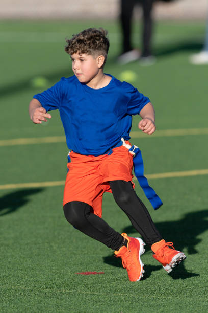 istock Young Athletic Boy Playing Flag Football 1299123609